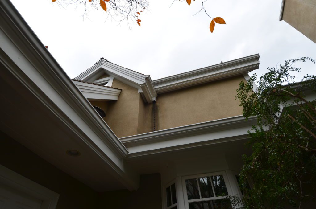 Image of stains on second floor walls from blowing water at missing downspout