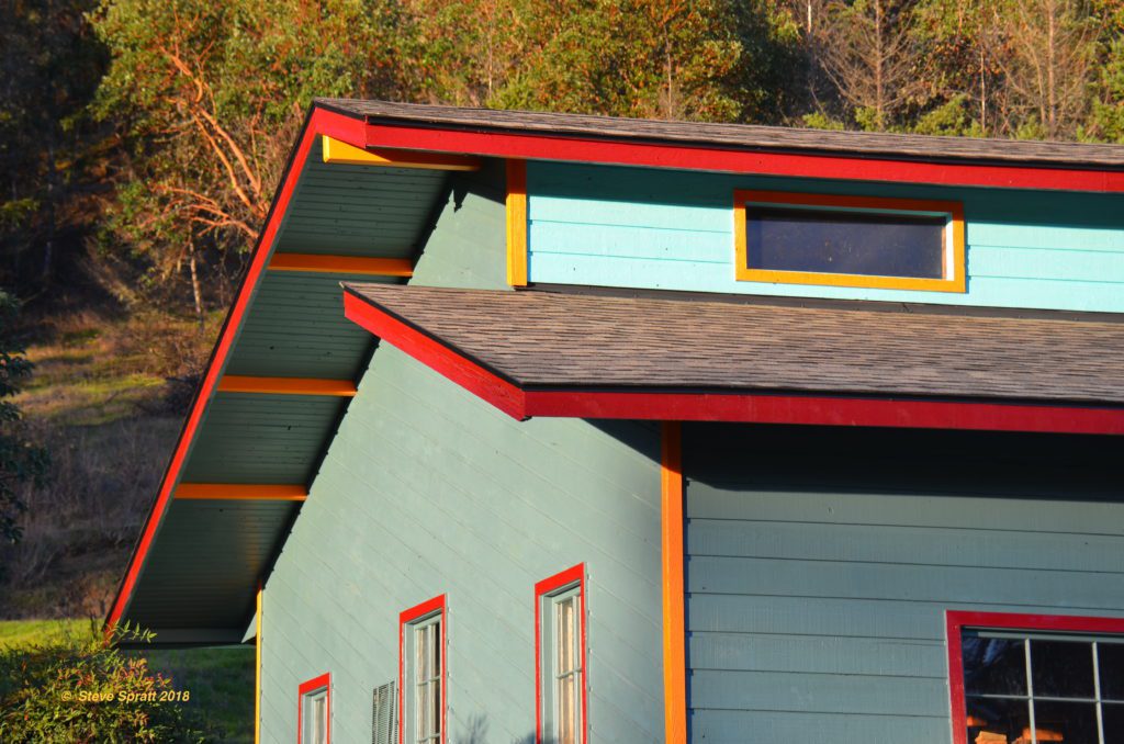 Striking blue/red colored home with wood siding