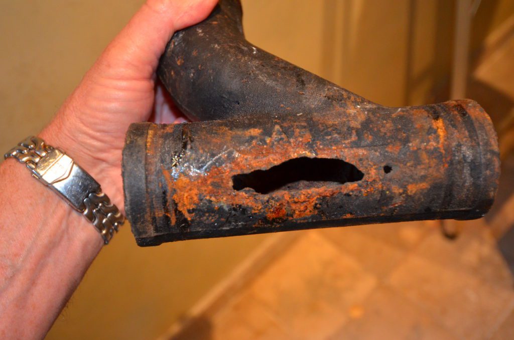 Image showing hole in drain pipe caused by chemical drain cleaner