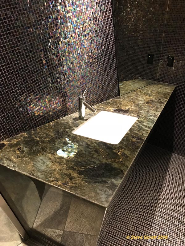 Image of bathroom vanity made of exotic glossy stone slab countertop