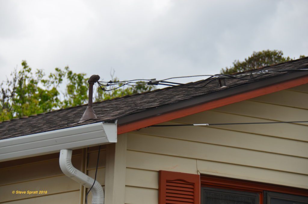 Image of old electrical service wires and mast on roof