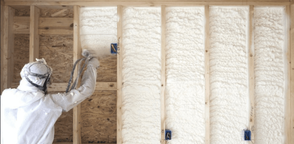 Image of spray foam insulation being installed in framing